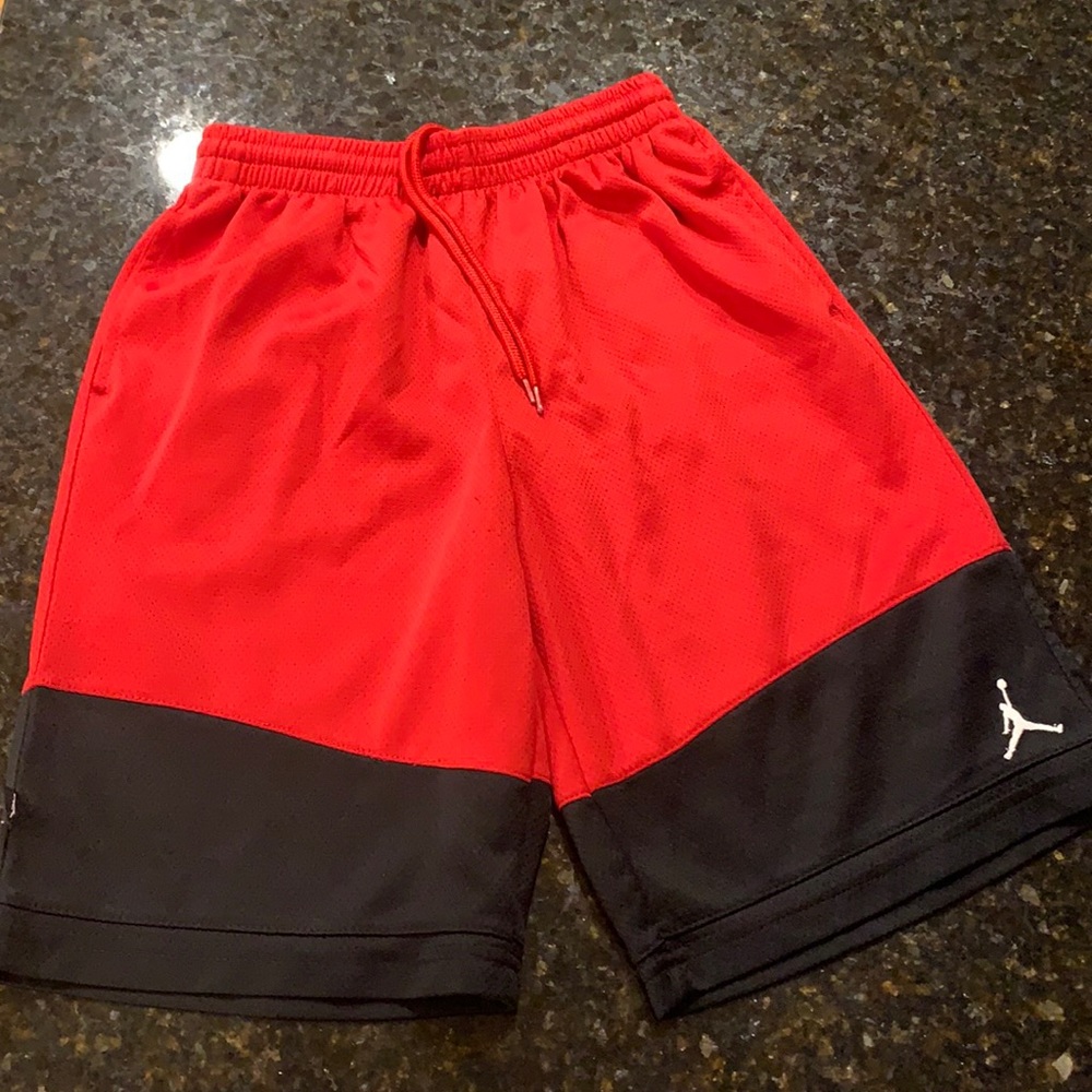 Red and black basketball shorts by Jordan, size Youth M